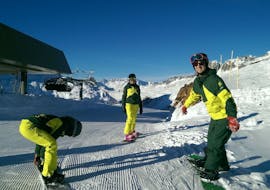 Ski instructors from the Snowlimit Andermatt ski school get ready for the private snowboarding lessons for kids and adults. 