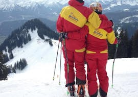 A couple enjoying the view during their Adult Ski Lessons for Experienced Skiers from Erste Skischule Bolsterlang.