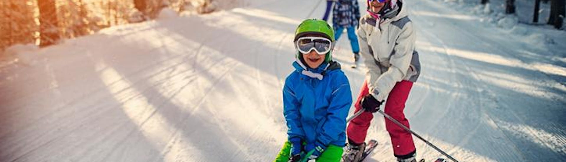 Children race down the slopes during their kids ski lessons for beginners (from 4 years) with the Edelweiss Alpine Ski School. 