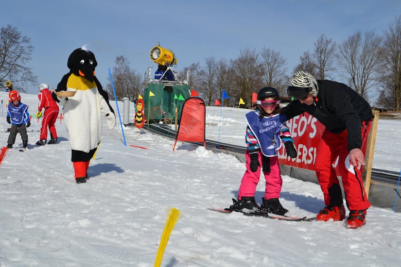 Een skileraar van de Skischule Sahneberg laat een klein meisje enkele oefeningen zien tijdens de privé skilessen voor kinderen en tieners voor alle niveaus.