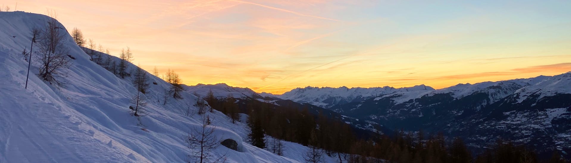 View of the snowy landscape you can see during an Introduction to Ski Touring at Sunset with Evolution 2 Peisey-Vallandry.
