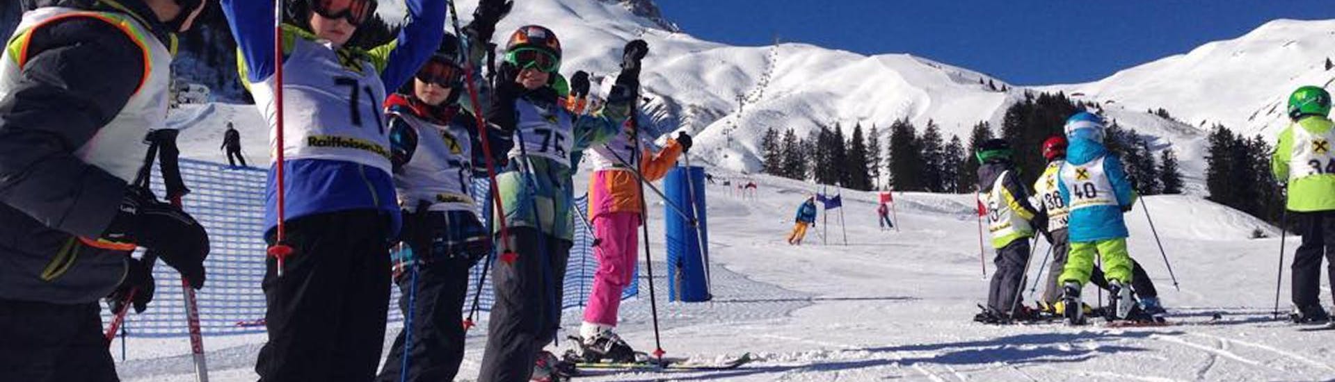 Eine Gruppe von Kindern jubelt beim Kinder-Skikurs für Anfänger mit der Skischule Warth in Warth-Schröcken.