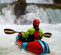 Man packrafting in front of a waterfall during the packrafting on the Mreznica River hosted by Raftrek Adventure Travel Croatia
