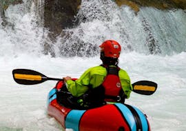 Man packrafting in front of a waterfall during the packrafting on the Mreznica River hosted by Raftrek Adventure Travel Croatia