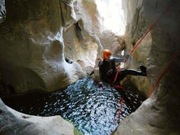 Man during abseil with 25Miglia during Underground Canyoning in Grotta Donini for Experts.