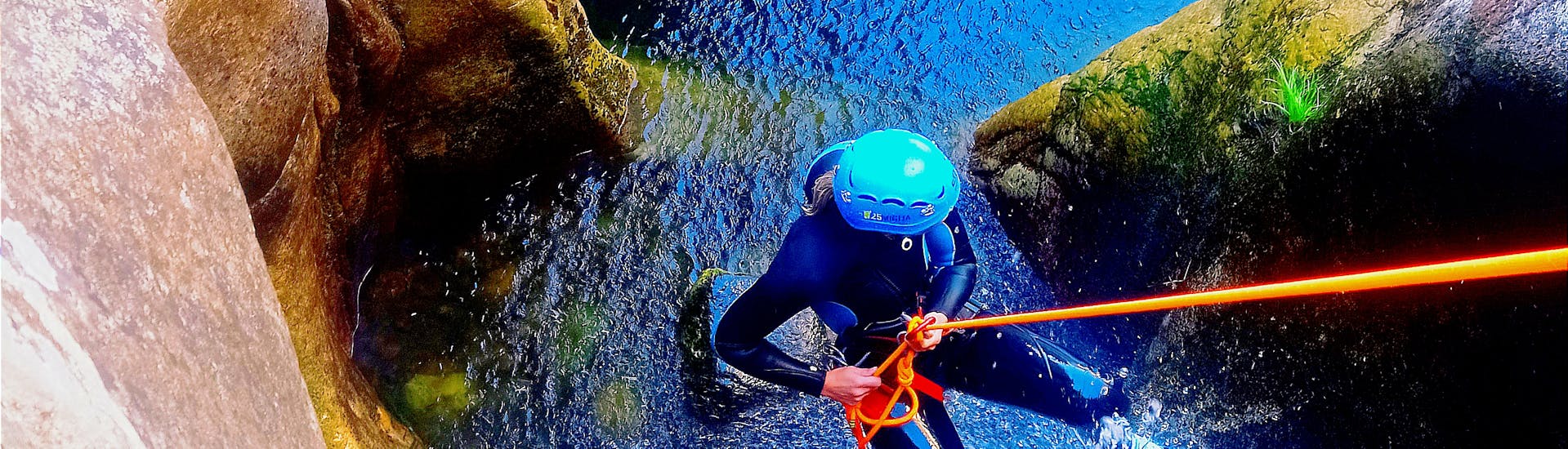 Person during abseil in canyon during Underground Canyoning in Grotta Donini for Experts with 25Miglia