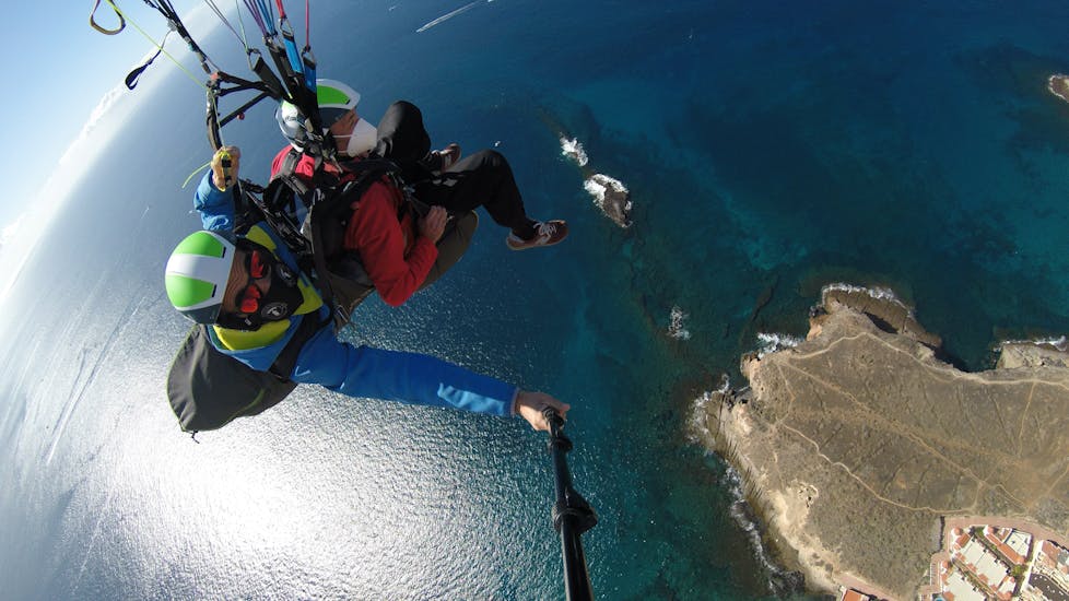 Two people enjoy a scenic tandem paragliding flight over Adeje - Ifonche Natural Park with Enminube Tenerife.