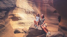 Two women inside a cave during the Red Canyon hiking tour with climbo.