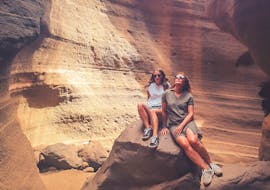 Two women inside a cave during the Red Canyon hiking tour with climbo.