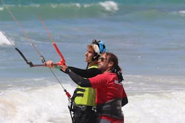 An instructor teaching during a Private Kitesurfing Lesson in Tarifa at Los Lances beach with Radikite.