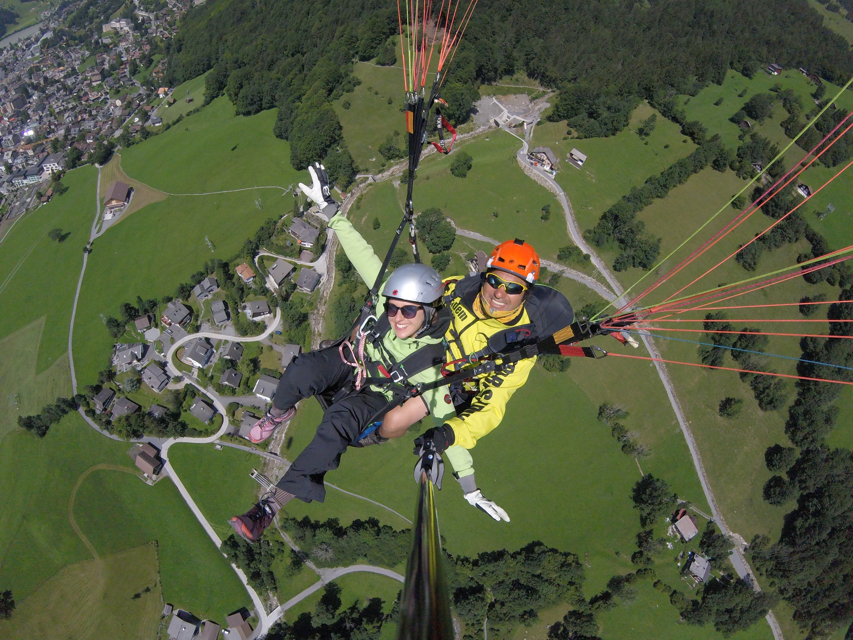 The pilot and a costumer gliding through the air while Tandem Paragliding from Brunni in Engelberg - Adventure with Paragliding Flybypara.