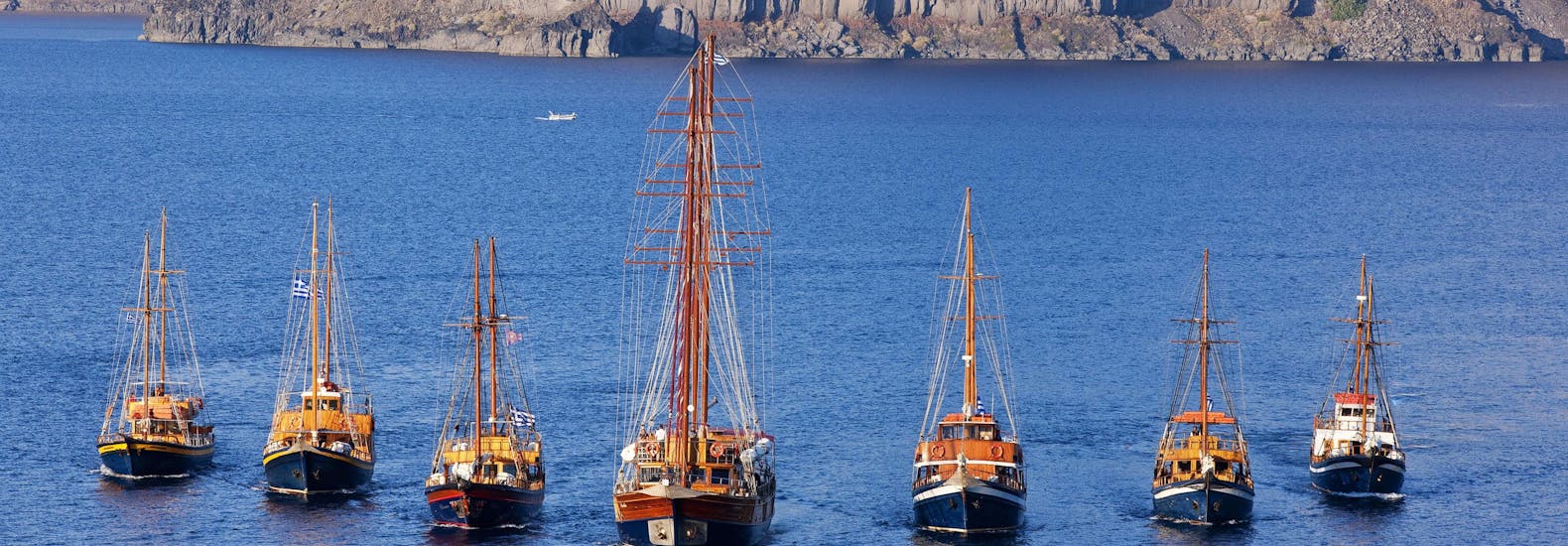 The fleet of boats available for the sunset sailing trip from Santorini to the Volcano with Caldera's Boats Santorini.