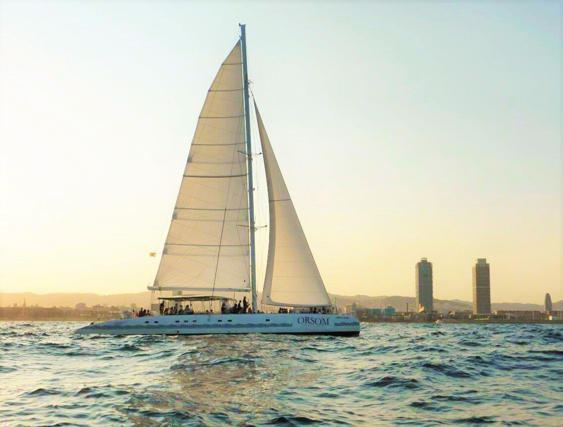 A boat sailing during a Catamaran Trip around Barcelona with Vermouth and Live Music with Catamaran Orsom Barcelona.