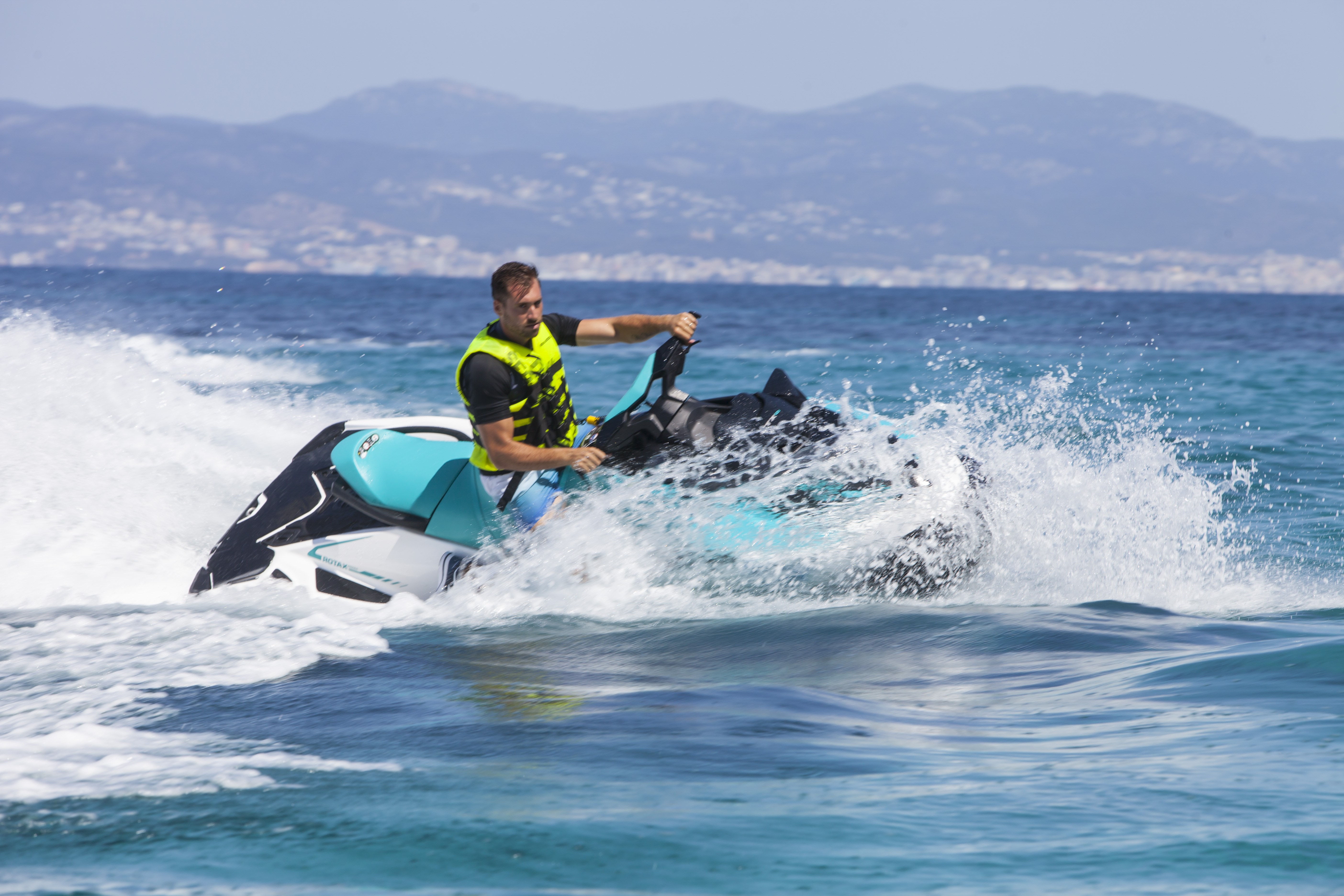 A guy riding a jet ski during a Jet Ski Safari at Cala D'or Beach with Cala d'Or on Jetski.