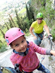 Mom and child climbing the Via Ferrata Sentiero Campione for Families with SKYclimber Tremosine