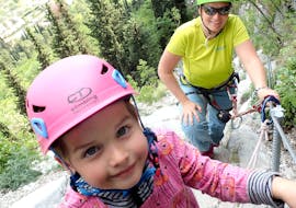 Mom and child climbing the Via Ferrata Sentiero Campione for Families with SKYclimber Tremosine
