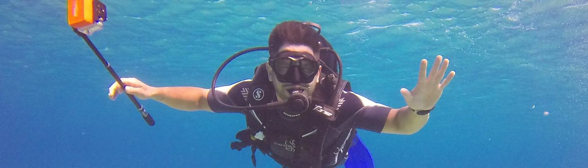 Ein Teilnehmer unter Wasser bei seinem ersten Tauchgang während des Discover Scuba Diving Kurses am Lia Beach in Mykonos mit GoDive Mykonos.