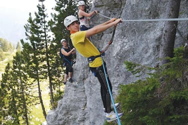 Three participants on a monkey bridge during the Via Ferrata of la Sambuy near Annecy with Terreo Canyoning.