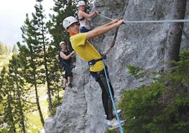 Three participants on a monkey bridge during the Via Ferrata of la Sambuy near Annecy with Terreo Canyoning.
