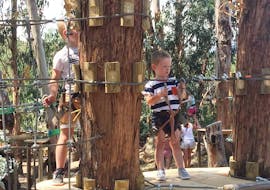A kid is doing the Adventure Park in Solenzara - Kids Route with Acqua et Natura Solenzara.
