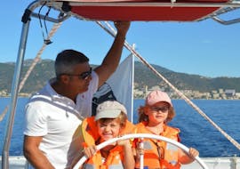 A family is doing a Private Catamaran Trip to the Sanguinaires Gulf with Snorkeling with Voglia di Mare. 