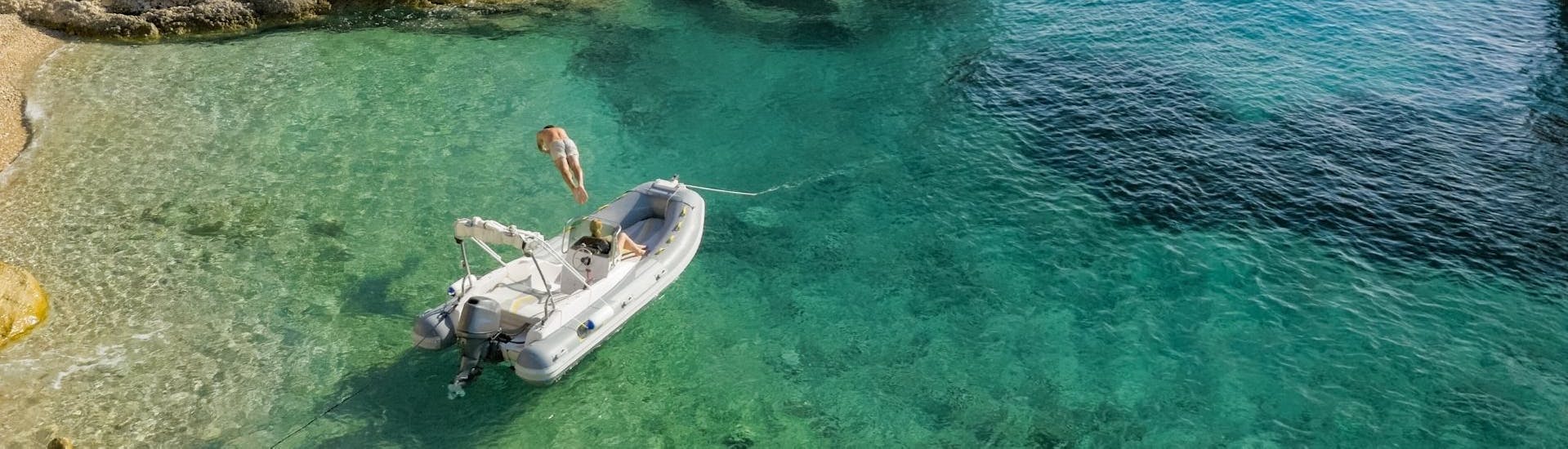 Eine Person springt ins klare Wasser während des Bootsverleih in Arbatax (bis zu 6 Personen) mit Flamar Vacanze Arbatax.
