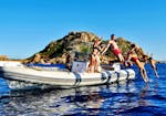 A group of friends jumping in the water from the RIB during RIB Boat Rental in Arbatax without License for up to 6 people.