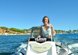 A woman is driving the RIB during RIB boat rental in Arbatax with license with Velamare Arbatax.