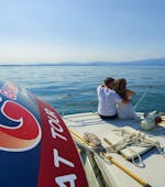 Twee toeristen genieten van een boottocht van Peschiera del Garda naar Sirmione met GardaVoyager.
