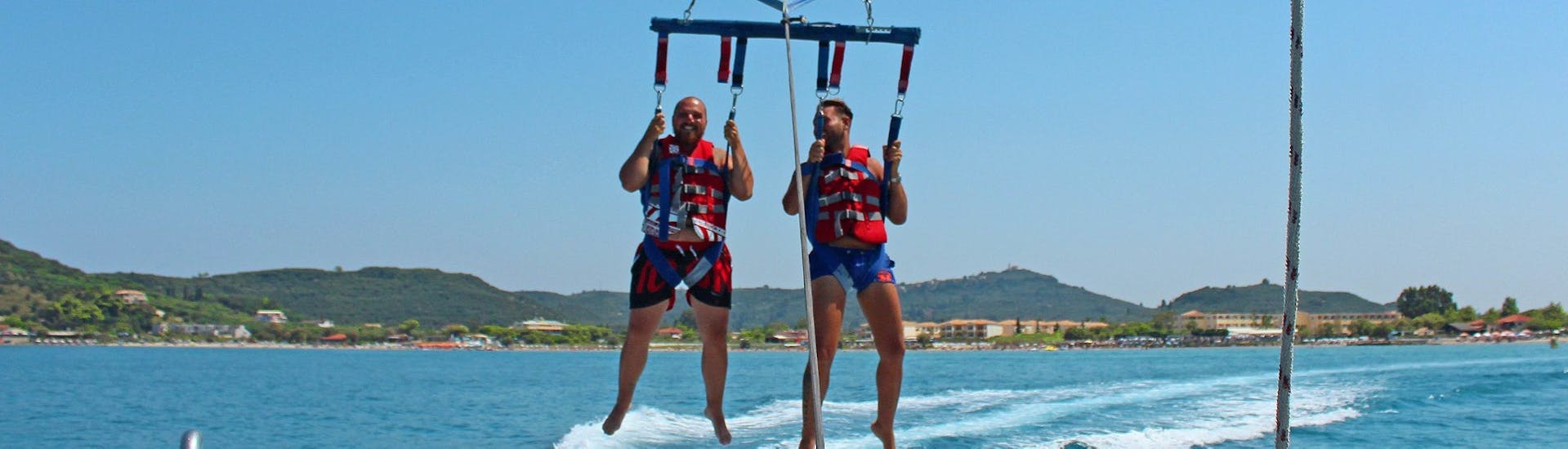 Two men during Parasailing in Alykes on Zakynthos with Alykes Water Sports Zakynthos.