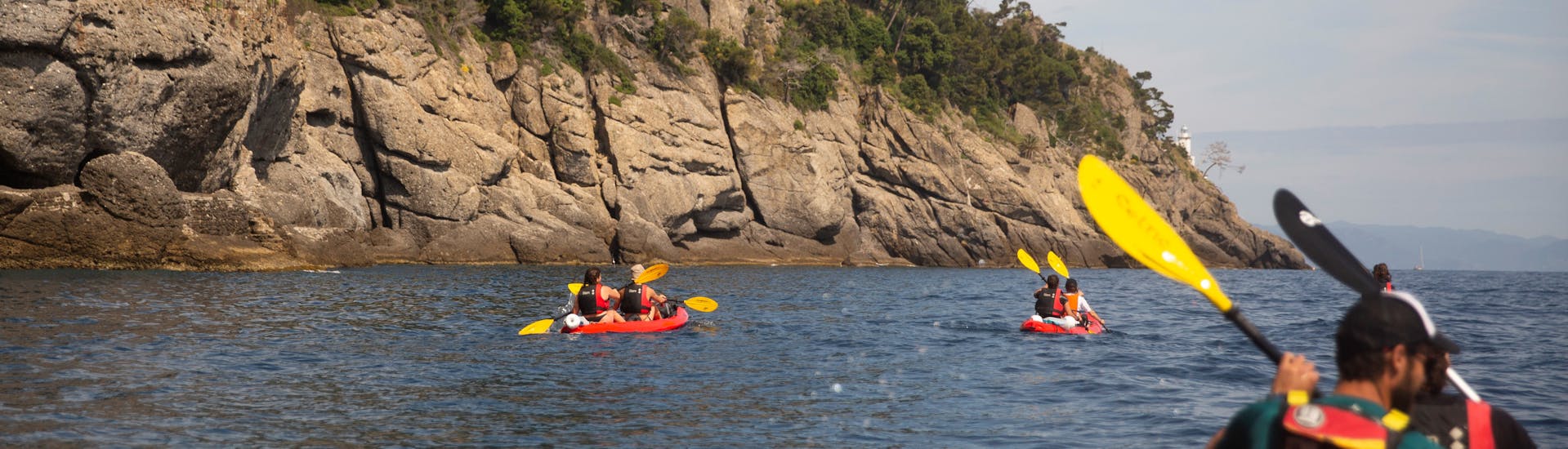 Kayaks in front of cliffs during our Kayak Tour along the coast of Portofino with Outdoor Portofino.