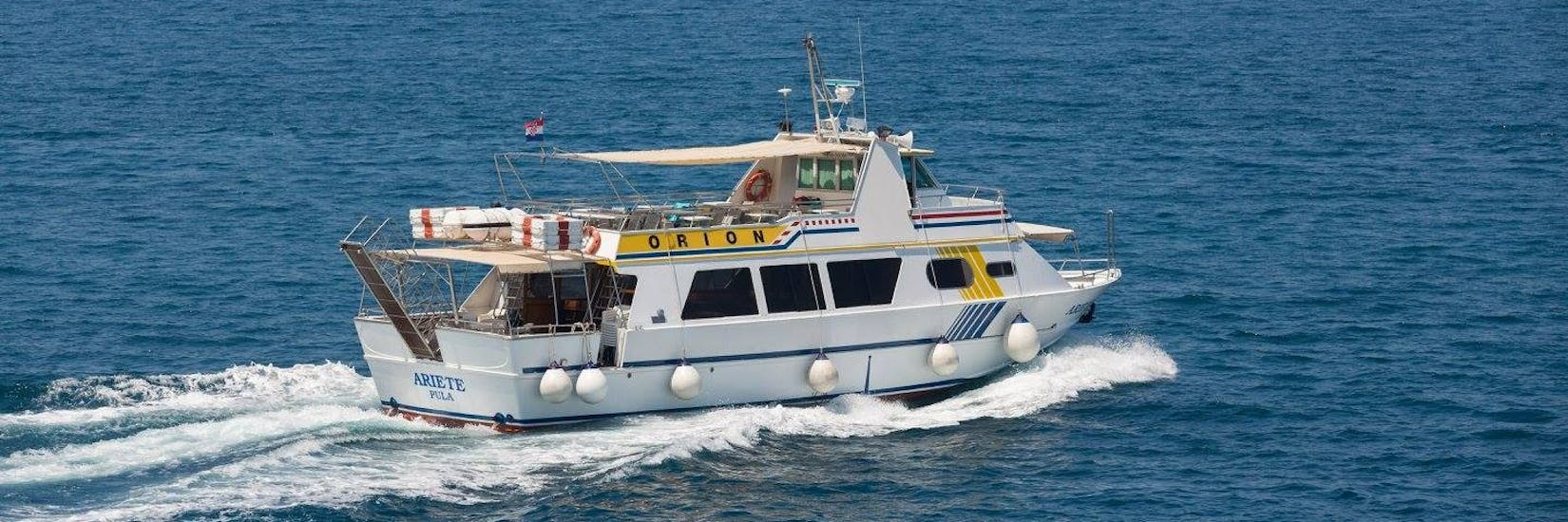 The boat from Orion Travel Pula on the sea during the Boat Trip from Pula to Rovinj.