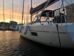 The sunset and a boat from Palmayachts Charters Portugal during the Private Sunset Boat Trip from Cascais.