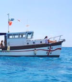 The wooden boat from Tour Express Villasimius navigating during the Private Boat Trip from Villasimius to Punta Molentis.