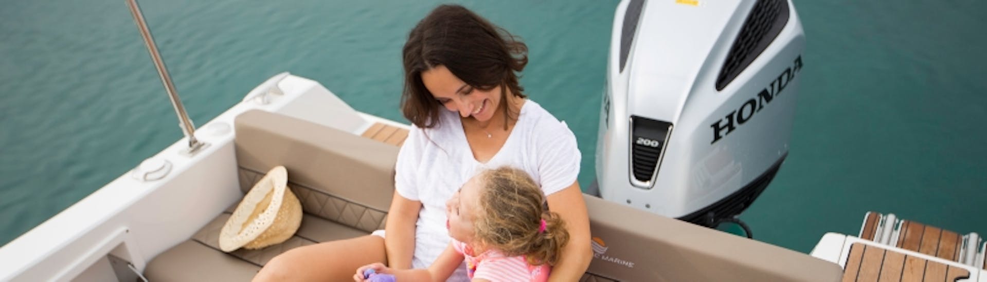 A woman and her daughter sailing during a Boat Rental in Pula (up to 7 people) with Victus Boats Pula.