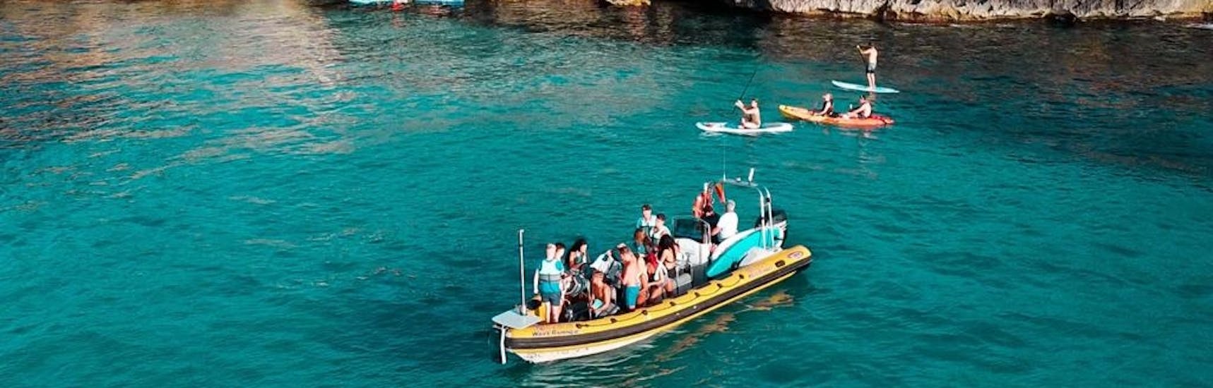 Partecipanti su un motoscafo che si fermano per una nuotata nelle acque turchesi della Baia di Alcudia durante una gita in barca da Can Picafort al parco naturale di Llevant con North Coast Adventure Mallorca.