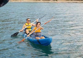 Two friends paddle along Alcudia Bay during a sea kayaking with North Coast Adventure Mallorca.