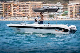 A guy sailing during a Boat Rental in Fuengirola (up to 6 people) with Fuengirola Sea Trips.