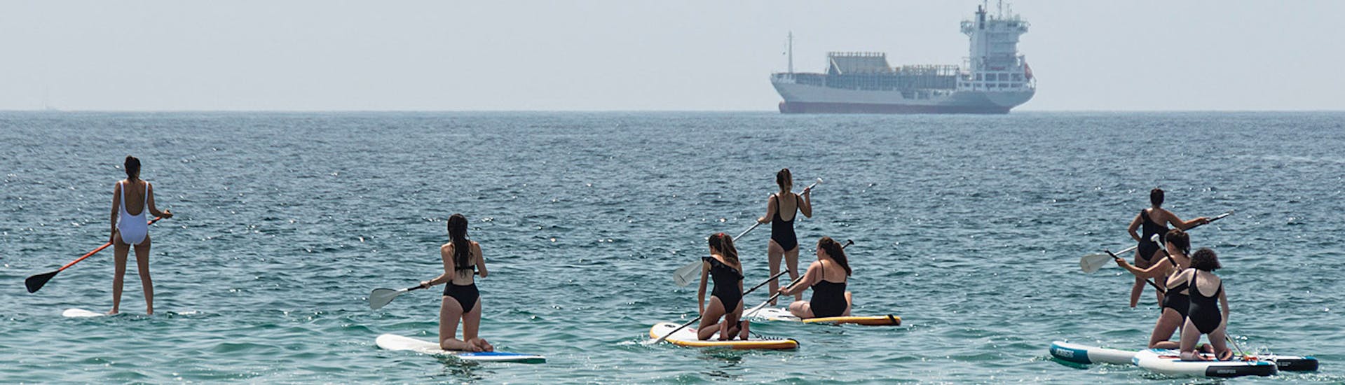 People practising SUP Lessons on Malagueta Beach for Beginners with Malagawake.