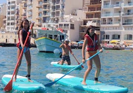 Participants enjoying the SUP in the bay during the SUP Hire in Spinola Bay in St. Julian's with Oki-Ko-Ki Banis Watersports St Julian's.