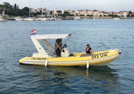 Two people on the boat from the Boat Rental with Licence in Umag (up to 8 people) with Action & Fun Umag.