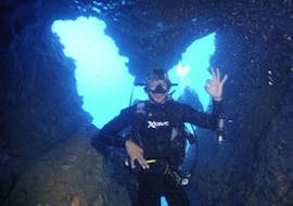 A participant is underwater showing a hand signal at PADI Discover Scuba Diving in Zakynthos with Diver's Paradise.