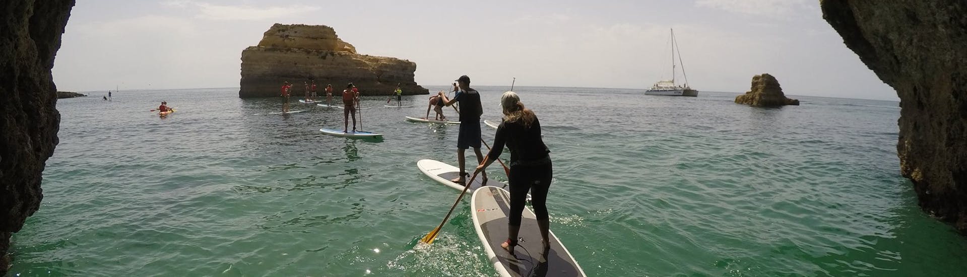 Group of people moving forward during the Stand Up Paddleboarding from Galé Beach along the Algarve Coast with Nautifun Galé Albufeira.