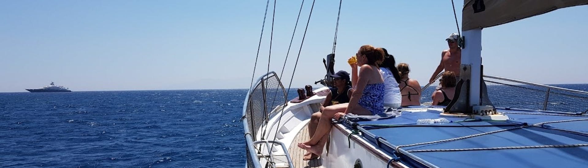 People on our traditional wooden woat during the Boat Trip to Delos & Rhenia from Mykonos with Mykonos Cruises.