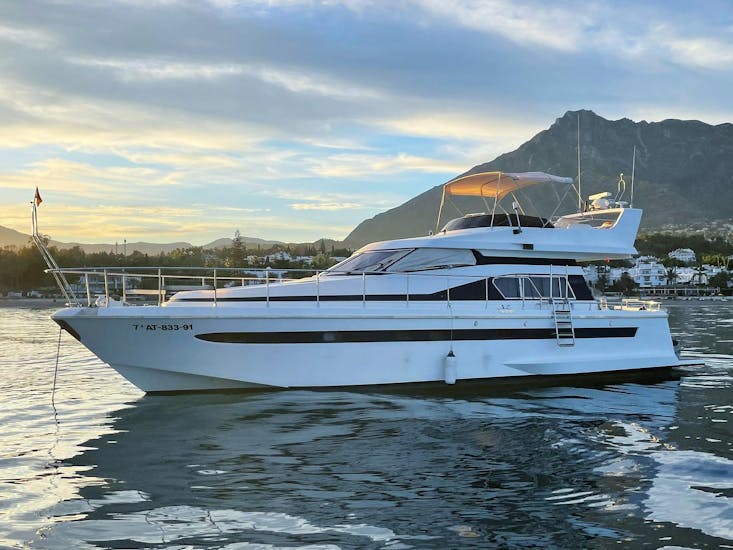 The luxurious ASTONDOA 50 GL yacht, standing during a beautiful sunset during an all-inclusive boat rental in Marbella for up to 12 people with Marbella Renting Boat.