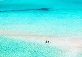 A couple standing on the beach of the balos lagoon during their Private Boat Trip to the Balos Lagoon & Gramvousa from Kissamos with Chania Balos Cruises.