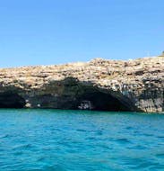 View of a boat in a cavve during our boat Trip to the Caves of Santa Maria di Leuca with Snorkeling.