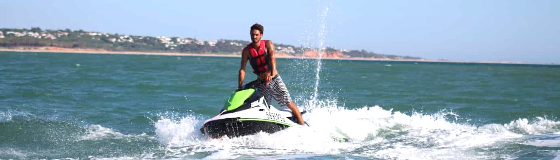 A guy riding a jet ski during a Jet Ski Safari at Vilamoura Beach in the Algarve with Vilamoura Watersports Centre.