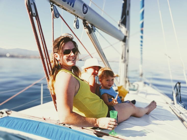 A mother and her kids enjoying a relaxing day at Estepona Bay during an all-inclusive private sailing boat trip in Estepona with South Olé Sails.