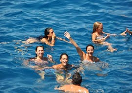 Two friends swimming during a Boat Trip from Palma to Cabrera Island with Swimming with Cormoran Cruises Paguera.